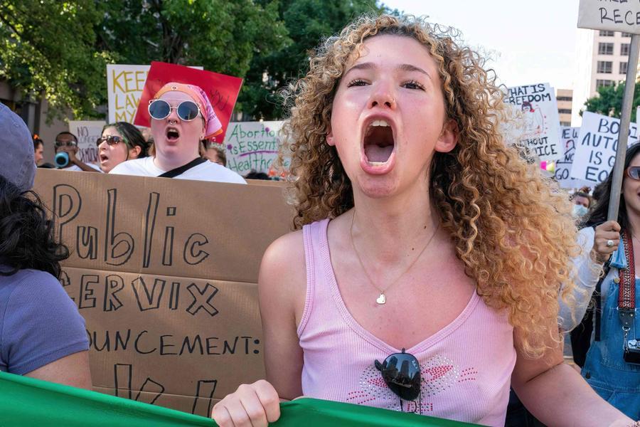 An abortion rights demonstrator chants slogans as they march near the State Capitol in Austin, Texas, June 25, 2022. - Abortion rights defenders fanned out across America on June 25 for a second day of protest against the Supreme Court's thunderbolt ruling, as state after conservative state moved swiftly to ban the procedure. (Photo by SUZANNE CORDEIRO / AFP)