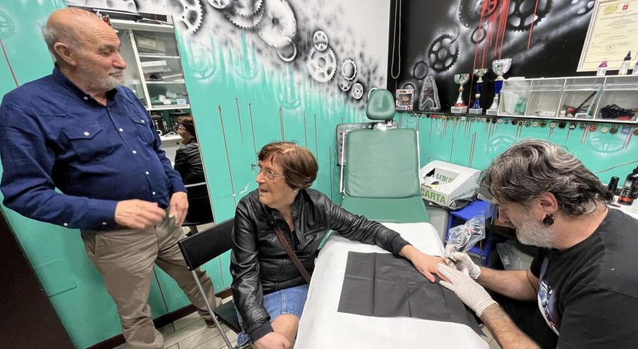 
	Gaetano e Ila nello studio di Michele Berretta a Pontedera durante il tatuaggio &ldquo;condiviso&rdquo; per i 50 anni d&rsquo;amore (Foto di Franco Silvi)

