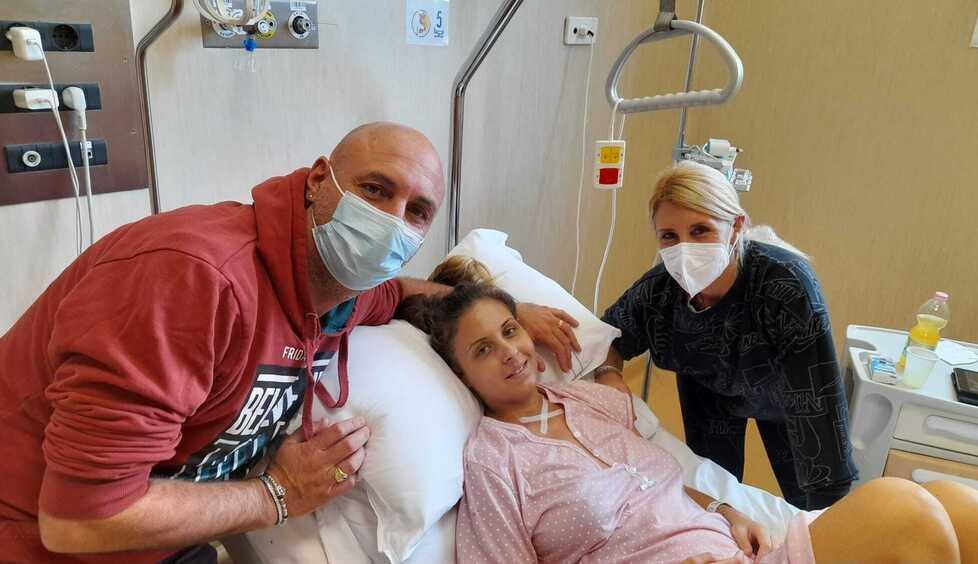 Il sorriso di Martina nel reparto di Ginecologia dopo 41 giorni di ricovero abbracciata dal babbo e dalla mamma (foto Corsi)