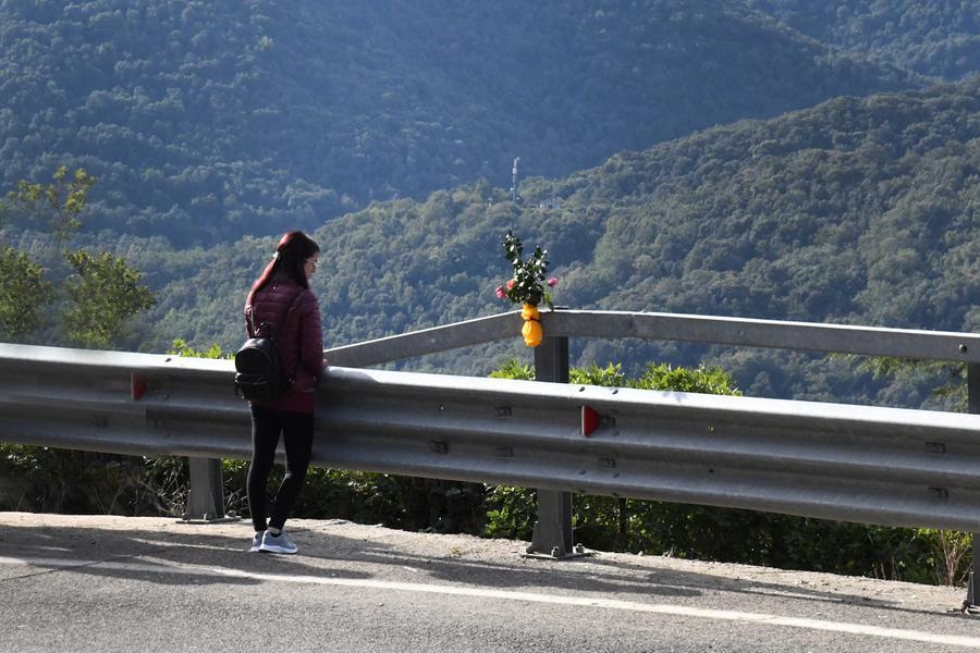 
	Una ragazza lascia un mazzo di rose vicino alla casa distrutta (foto massimo locci)


