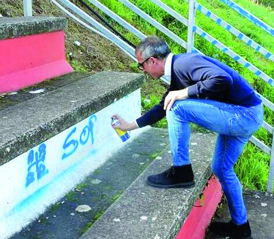 L'assessore Roberto Desini nello stadio di Bonorva mentre copre i graffiti