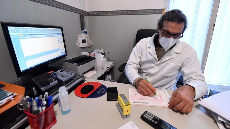 Un medico di base compila una ricetta