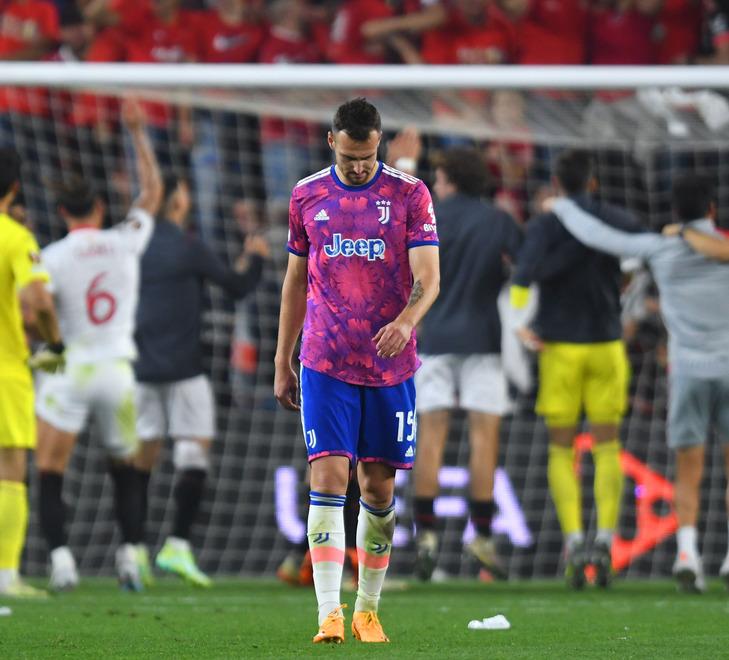 Federico Gatti lascia il campo di Siviglia dopo l’eliminazione in semifinale di Europa League mentre gli spagnoli festeggiano sotto la curva