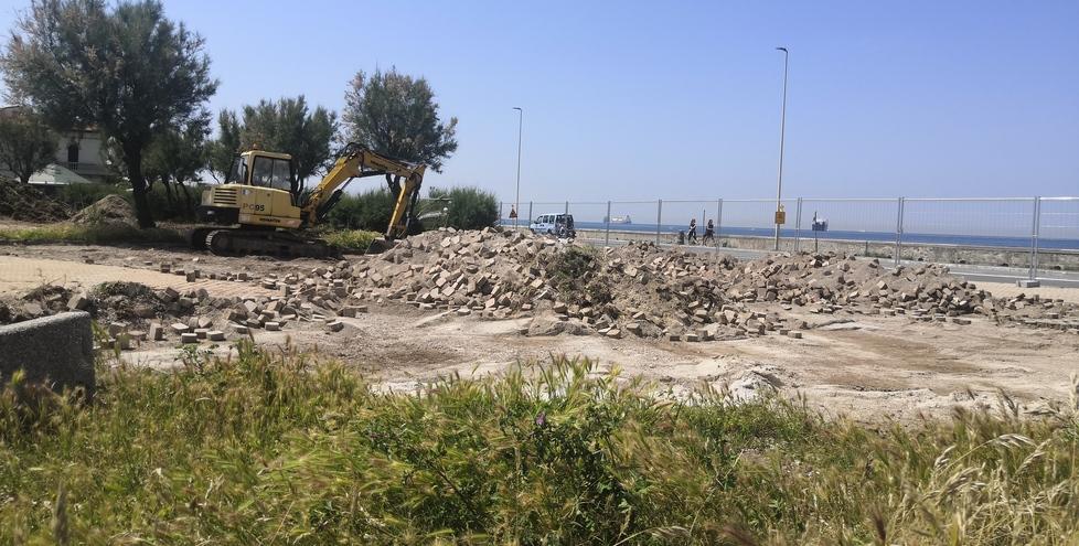 La ruspa ha appena rimosso un quantitativo di mattonelle autobloccanti che ricoprivano il marciapiede in largo Christian Bartoli