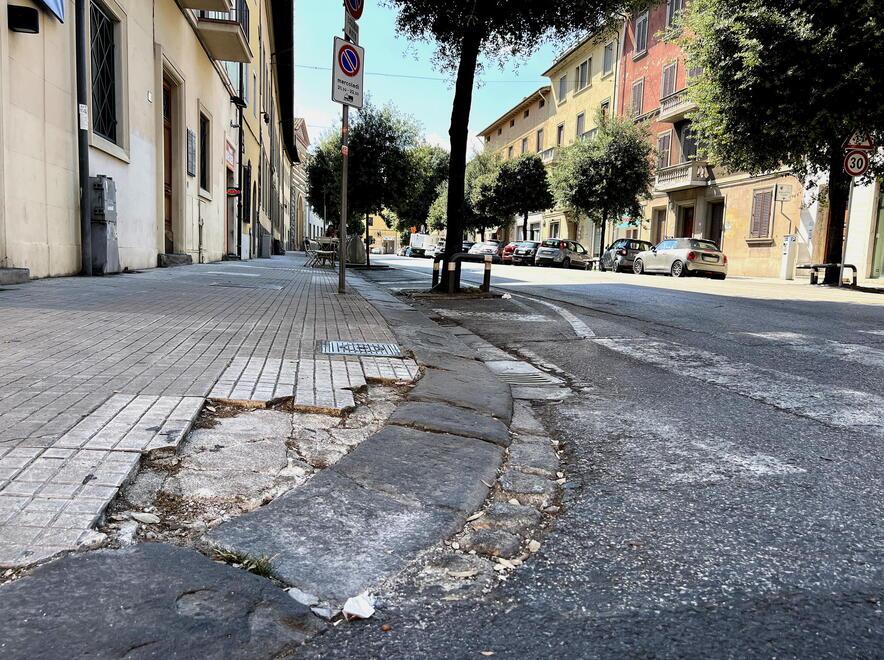 Un marciapiede sconnesso all’incrocio tra corso Gramsci e via dell’Ospizio (foto Nucci)