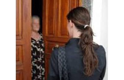 
	Un'anziana diffidente sulla porta di casa davanti a una sconosciuta

