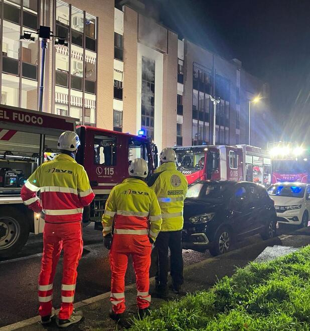 I volontari della Svs con il medico del 118 insieme ai vigili del fuoco fuori dallo stabile in fiamme in viale Città del Vaticano