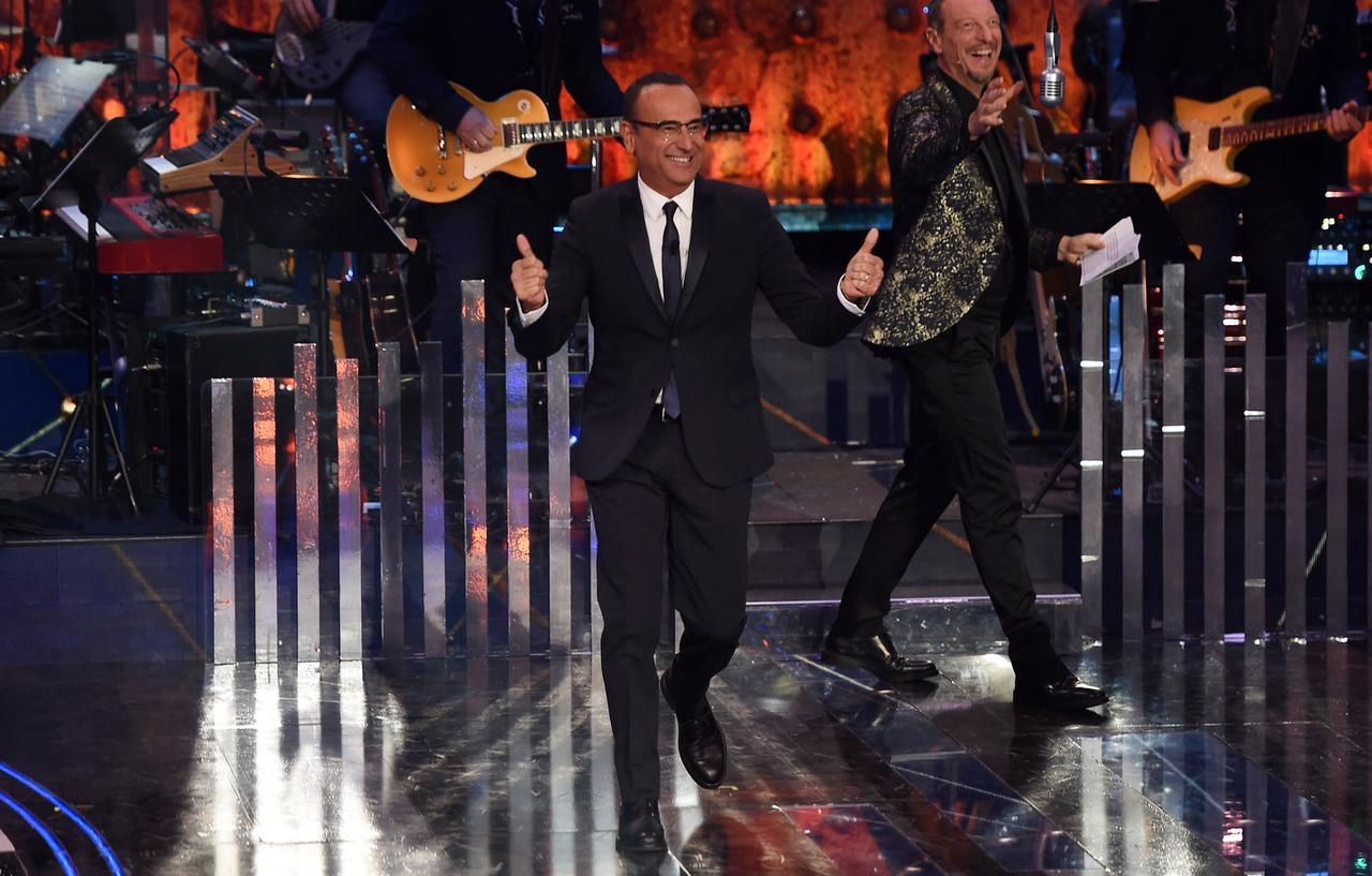 
	Carlo Conti sul palco di Sanremo giovani nel 2019 insieme al conduttore Amadeus

