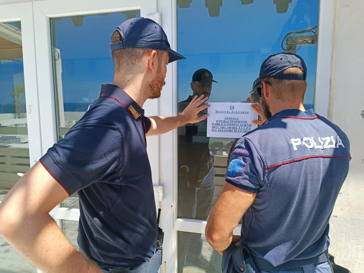 
	Due poliziotti sistemano il cartello &ldquo;attivit&agrave; sospesa&rdquo; a Calafuria

