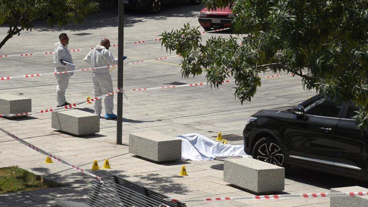 Gli inquirenti nella piazza dove è avvenuto l'omicidio <em>(foto Massimo Locci)</em>