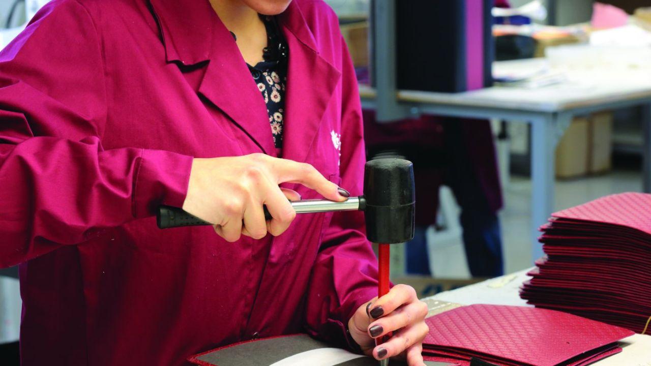 Un’addetta del comparto al lavoro in un’azienda del settore della pelletteria.  (foto d’archivio)