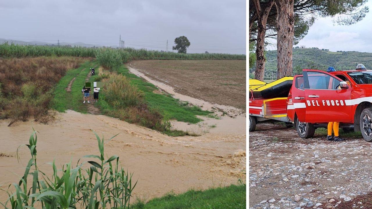 I due giovani bloccati dopo che il primo argine del Cornia ha ceduto e i mezzi dei vigili del fuoco