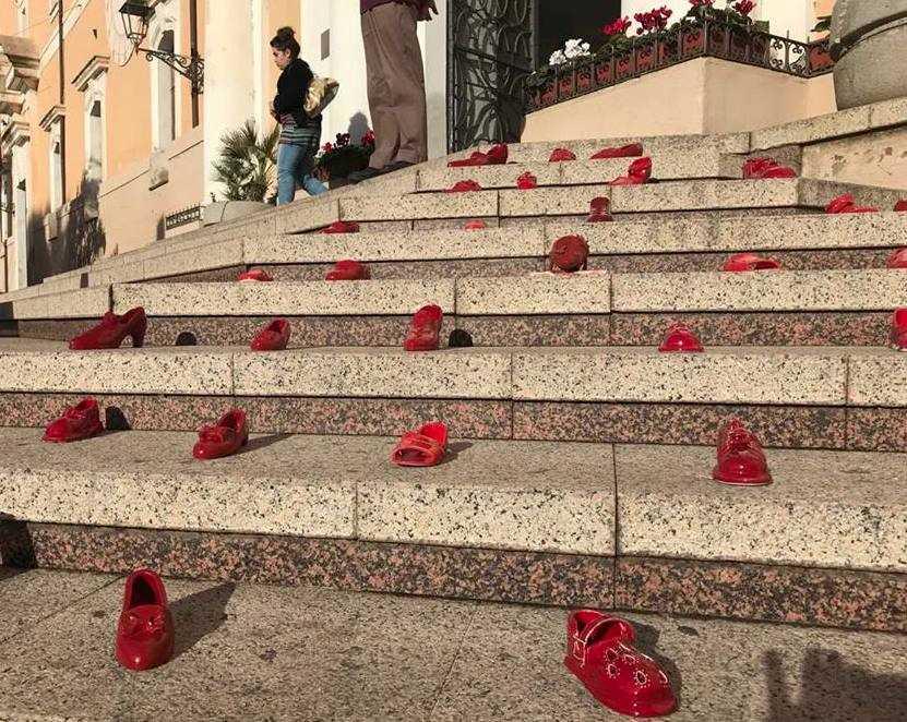 
	Scarpette rosse sulla scalinata del municipio in piazza Eleonora

