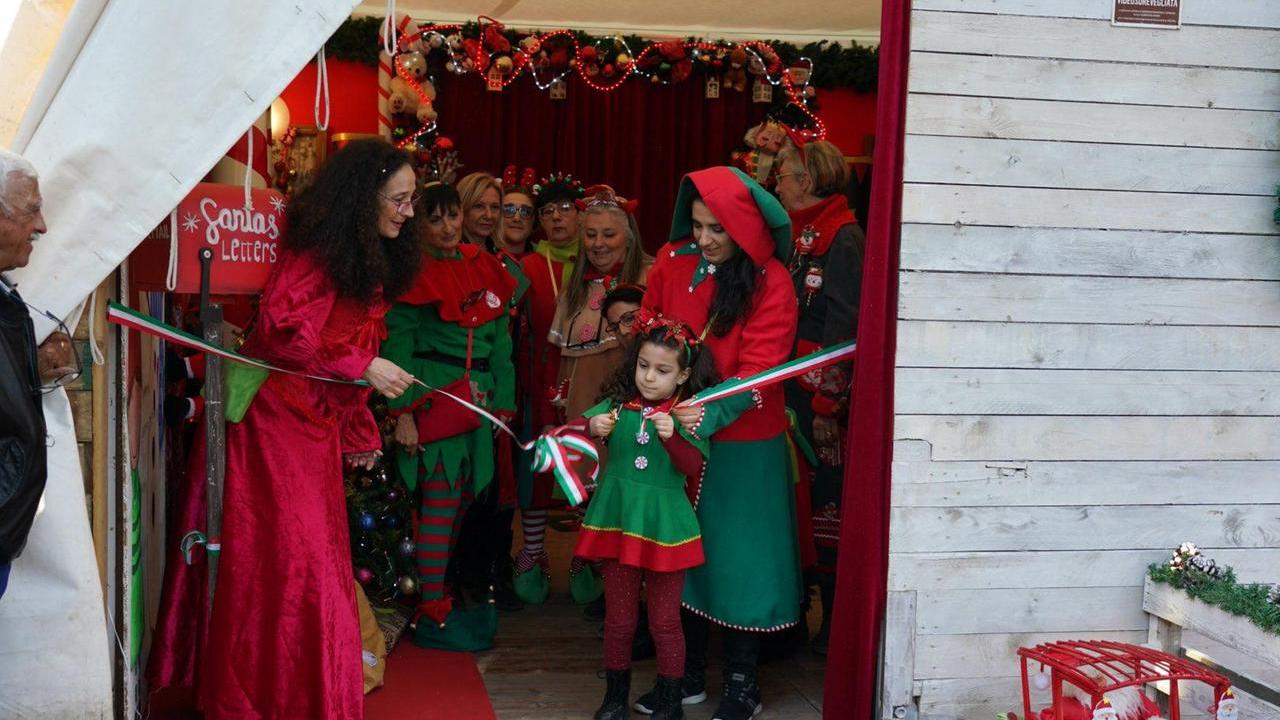 Una piccola elfa taglia il nastro del Villaggio di Natale dell’anno scorso in villa Fabbricotti (foto Silvi)