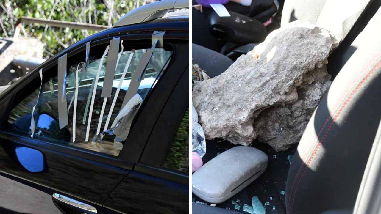 La macchina danneggiata e il masso (foto Cuffaro)