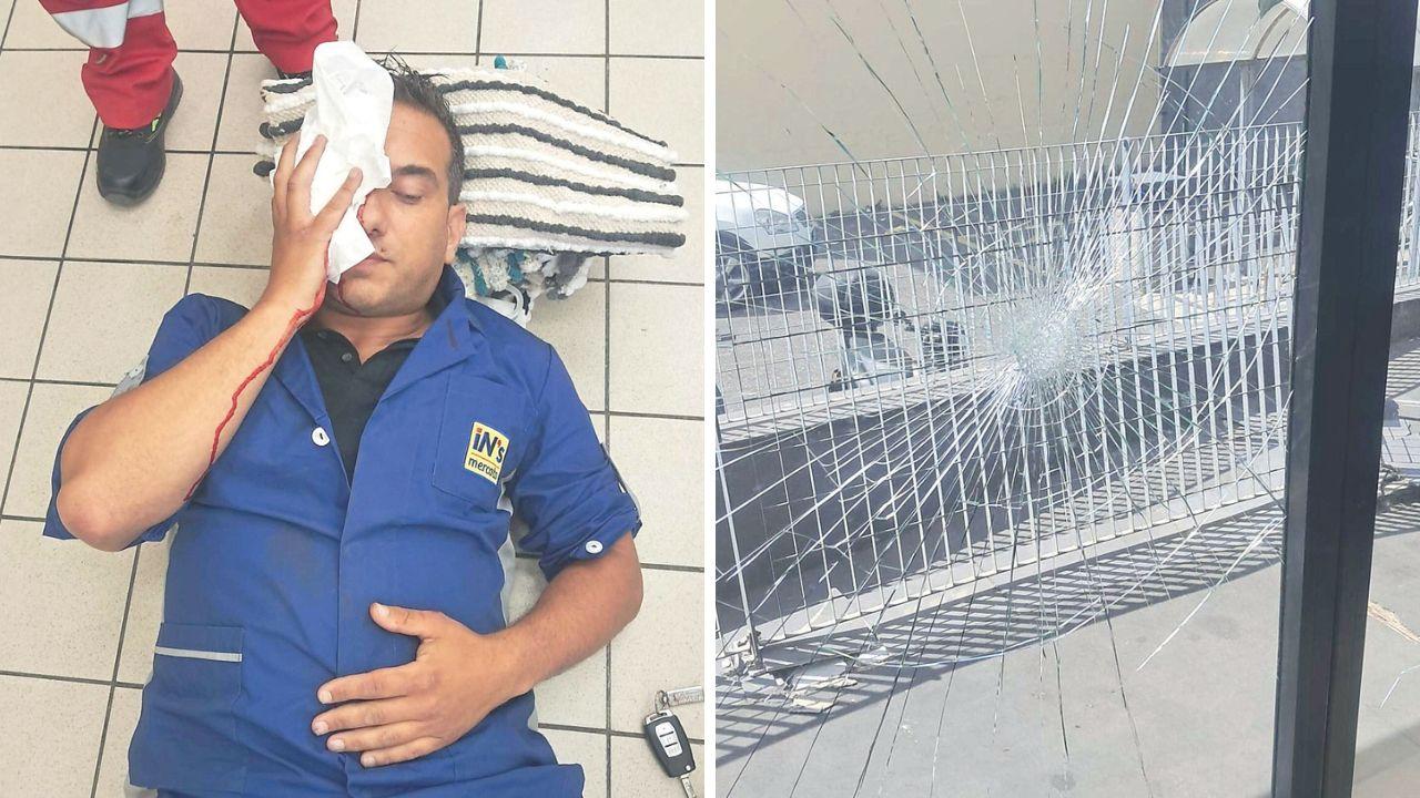 
	Tommaso Giacomelli durante i soccorsi e la vetrata della porta del negozio distrutta dal responsabile dell'aggressione

