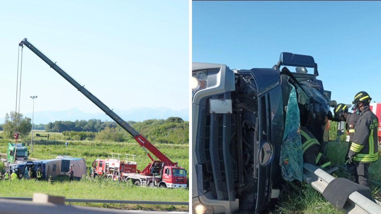 Il camion ribaltato nella zona industriale del porto di Livorno (foto Stick) e l'intervento dei vigili del fuoco per liberare il conducente