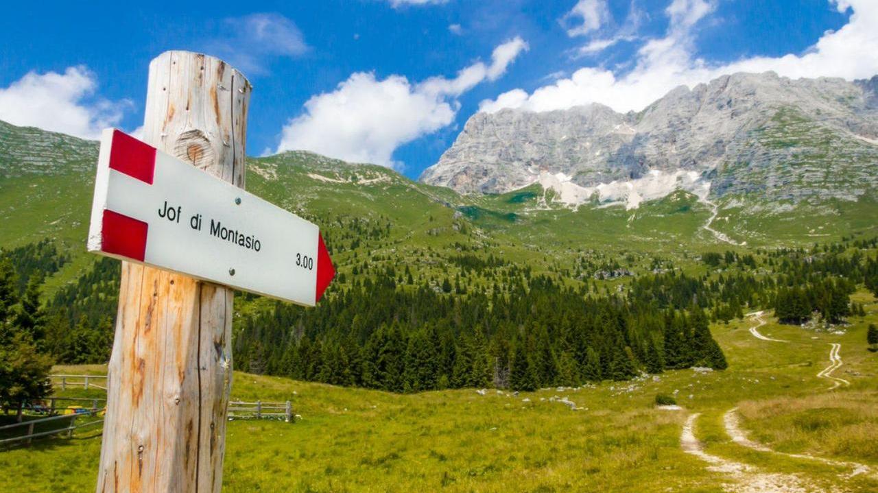 Un cartello indica il sentiero per il Montasio