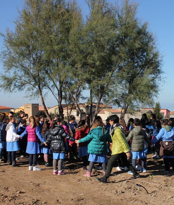 I bambini piantano gli alberi per far nascere il parco giochi