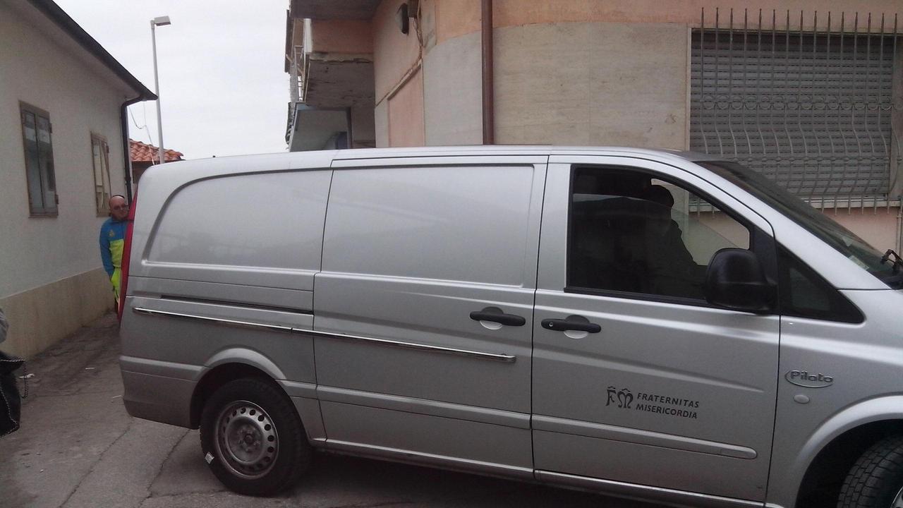 Il carro funebre mentre porta via il corpo dell'uomo
