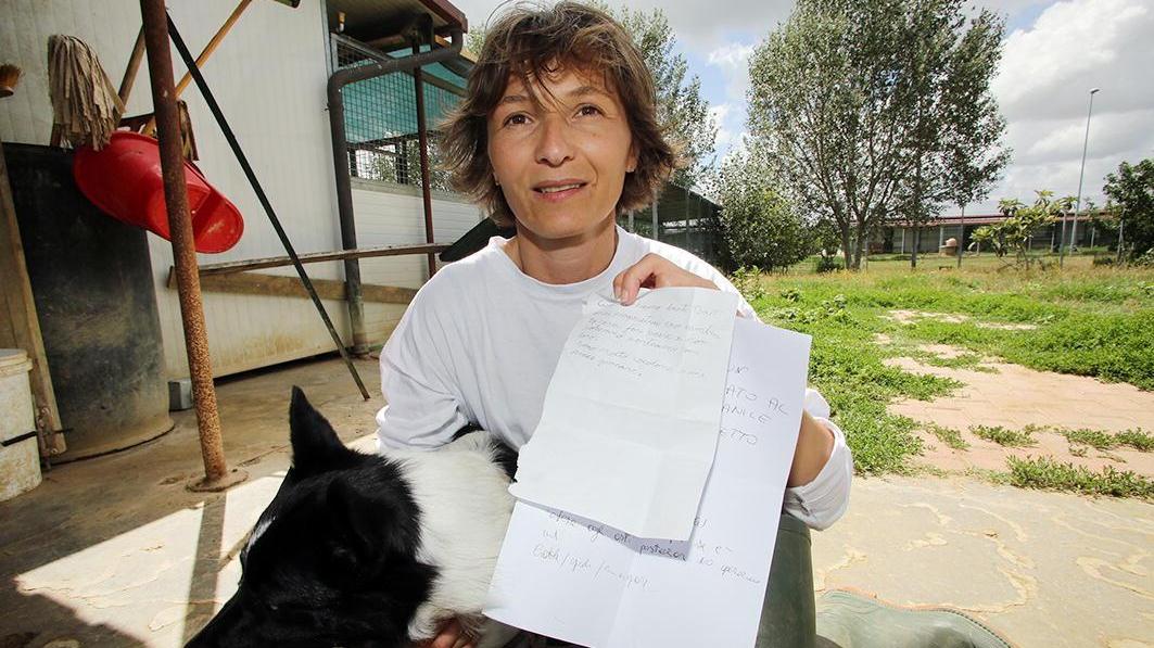 Il cane Bart con una volontaria e con il foglio con cui venne trovato