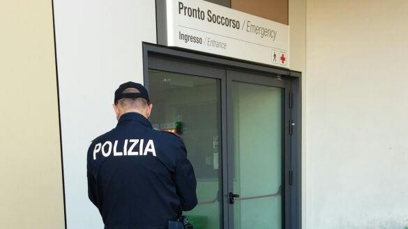 un agente della squadra volante di fronte al pronto soccorso dell'ospedale San Luca