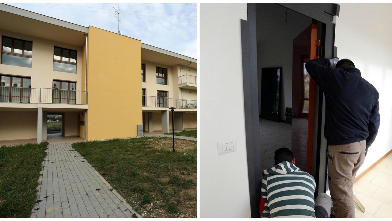 Le case popolari di Serravalle e gli operai impegnati a “blindare” una porta (Foto Agenzia Carlo Sestini)
