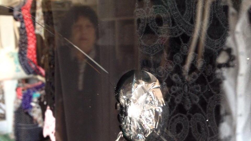 Il vetro della boutique danneggiato (foto Gio' Di Stefano)