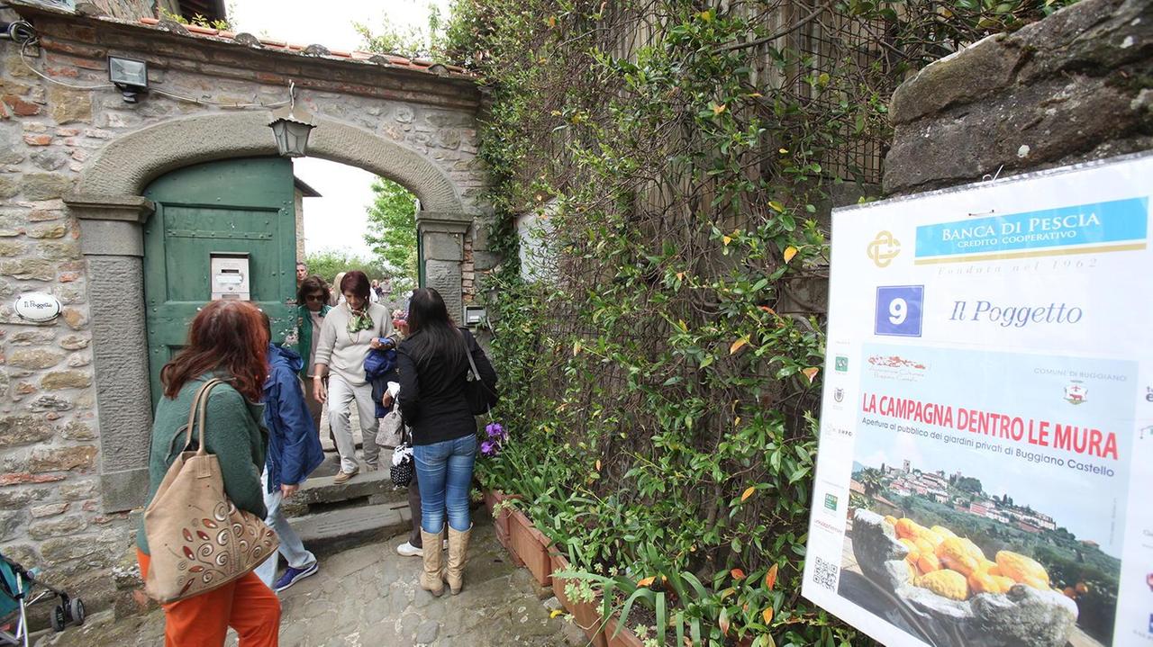 Attraverso un portone l'ingresso a uno dei giardini (foto Nucci)