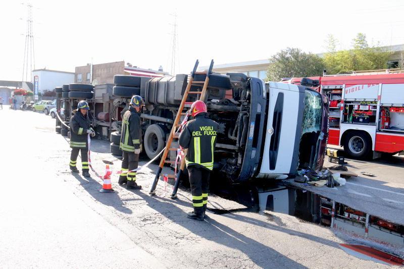 Il camion ribaltato e i pompieri in azione (Marzi/Pentafoto)