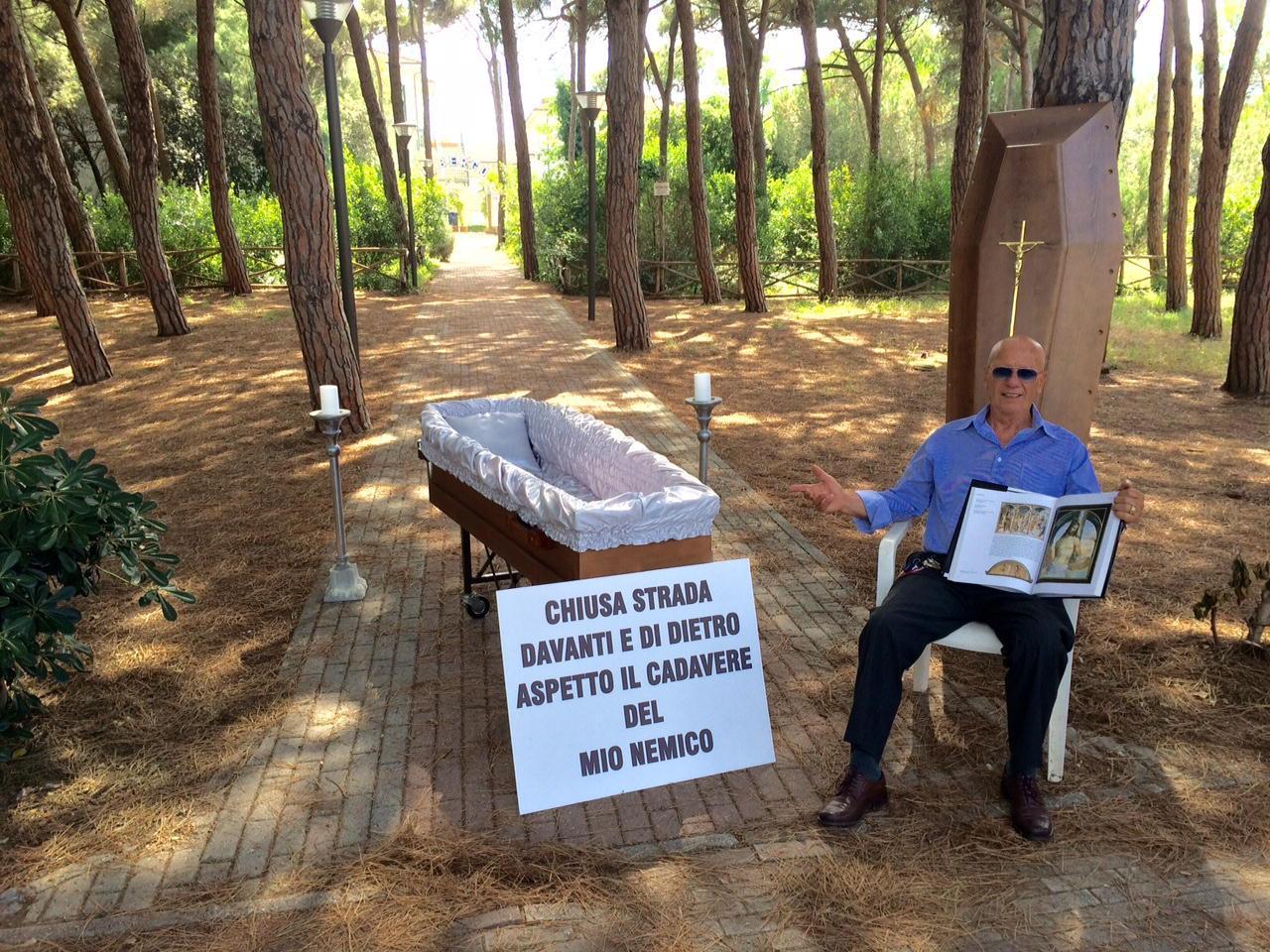 Giorgio Chisci con la bara nella pineta davanti al suo albergo