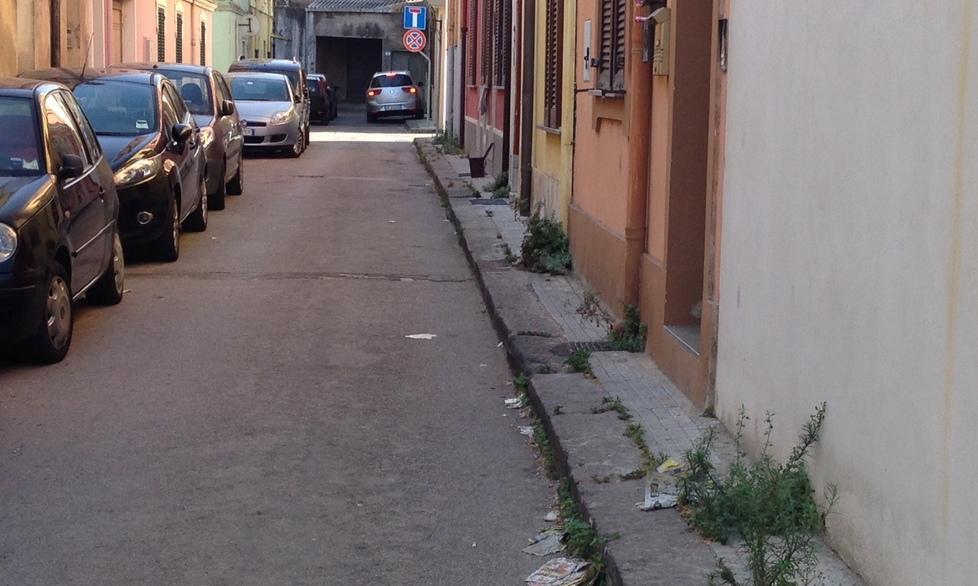 Strada sporca e invasa dalle erbacce