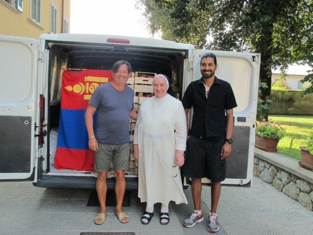 Umberto Colaone al centro madre Paola e Massimo Illiano mentre consegnano il camion con la frutta donata