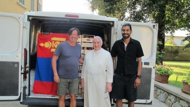 Umberto Colaone al centro madre Paola e Massimo Illiano mentre consegnano il camion con la frutta donata