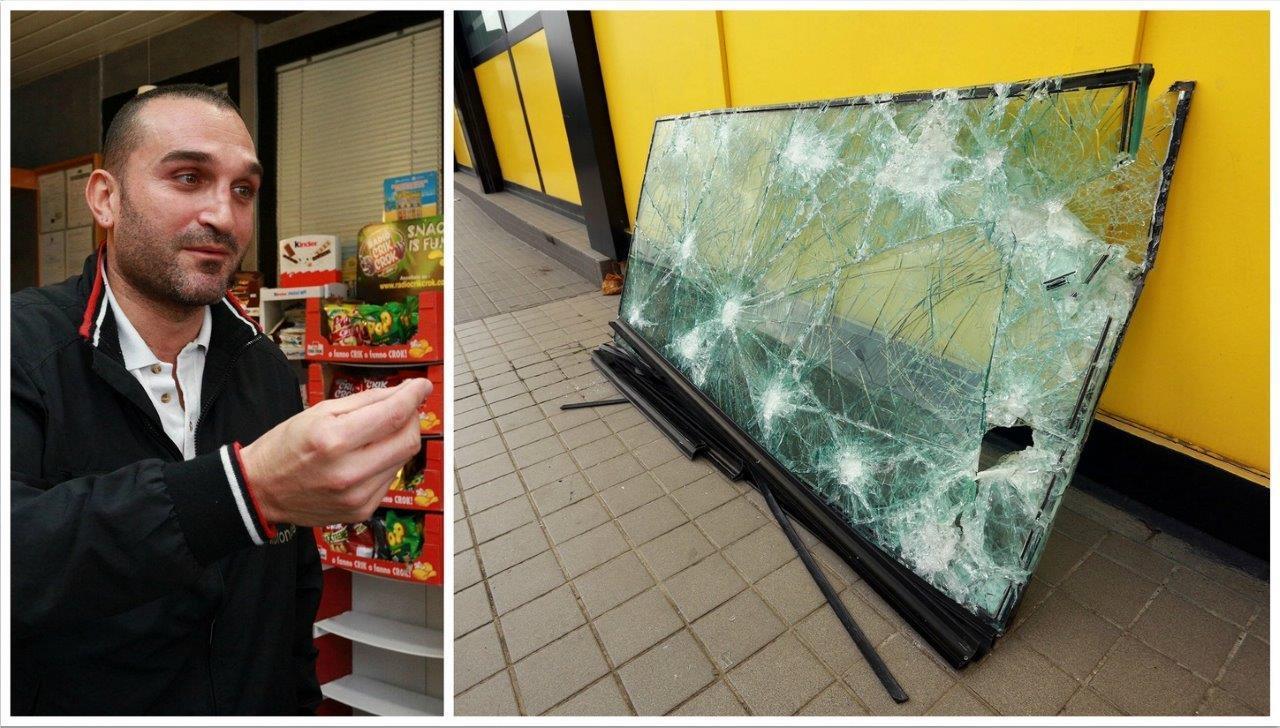 Marco Matteuzzi e il vetro sfondato nel suo bar (Foto Agenzia Carlo Sestini)