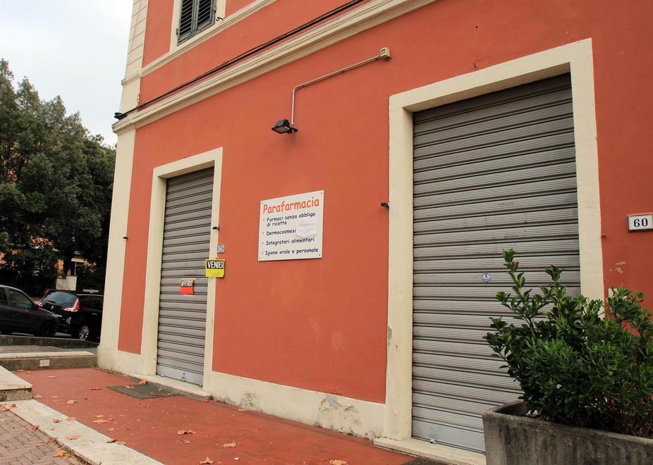 La parafarmacia di viale Fedeli con affissi i cartelli “affittasi fondo” e “cedesi attività” (foto Nucci) 