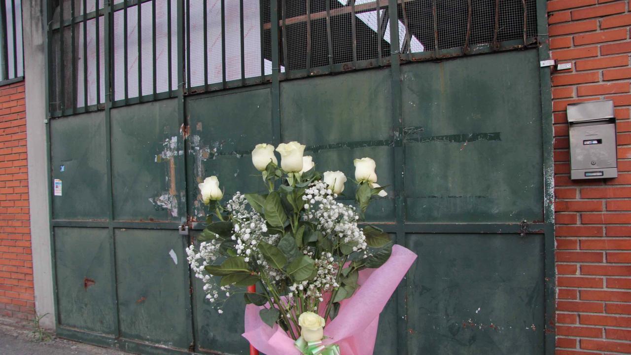 Un mazzo di rose bianche davanti all'ingresso della confezione Teresa Moda