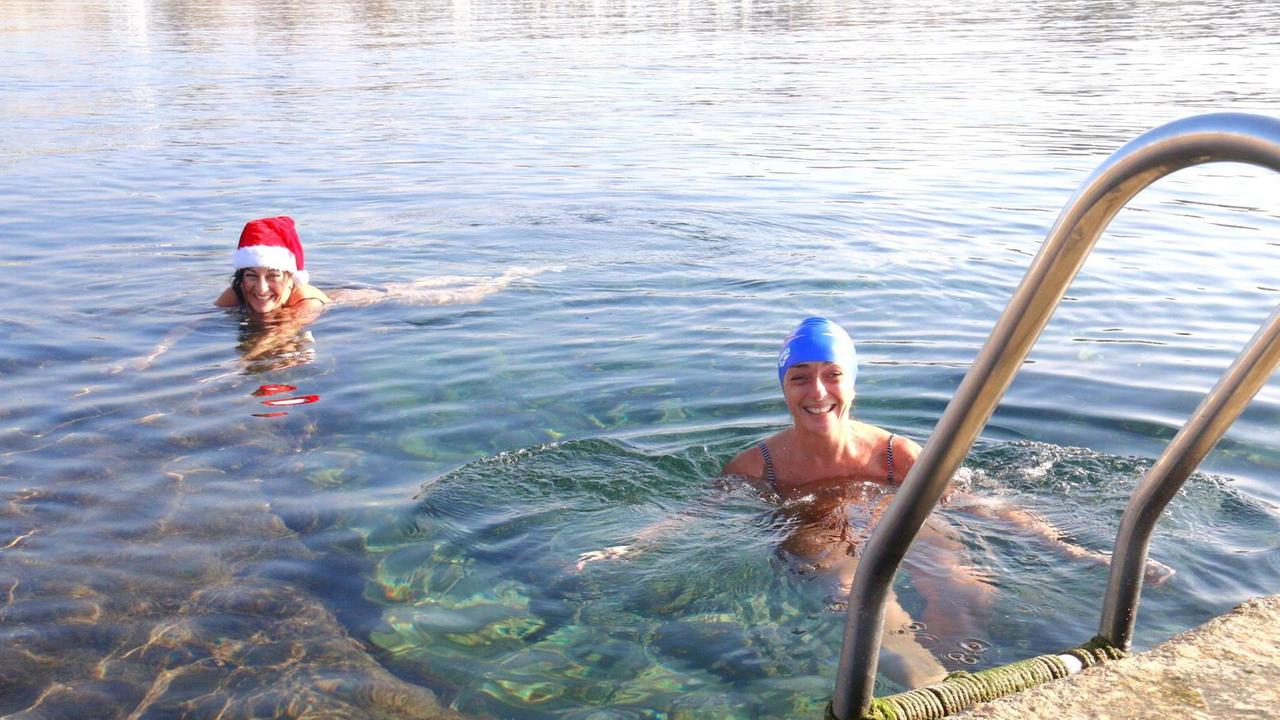 Due bagnanti in acqua per l'ultimo bagno prima di Natale (Marzi Pentafoto)