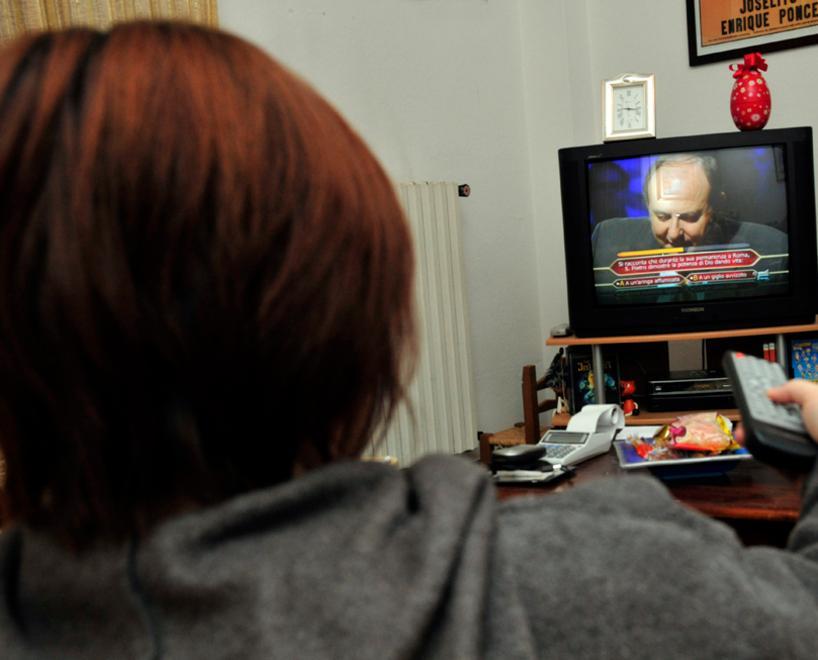 Una donna guarda un programma televisivo