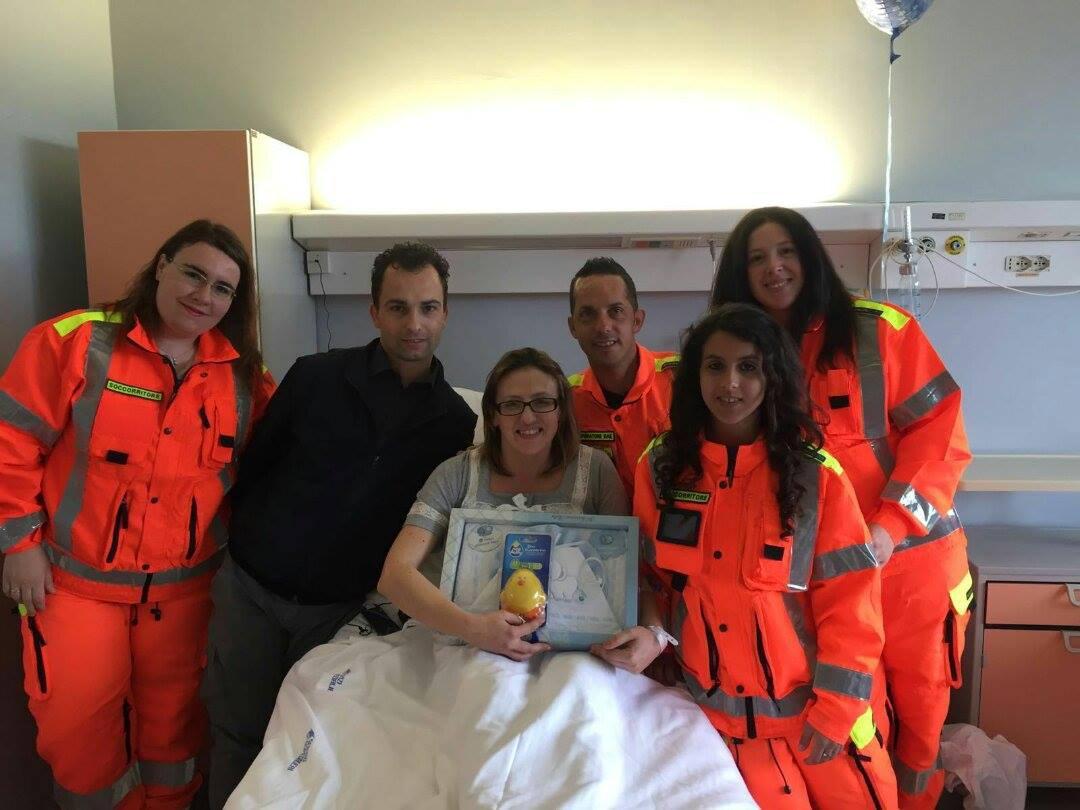 La mamma Vanessa Letizia Ginesi con Stefano Pellegrini, direttore dei servizi della Croce bianca di Querceta e i volontari della squadra che ha partecipato all'intervento