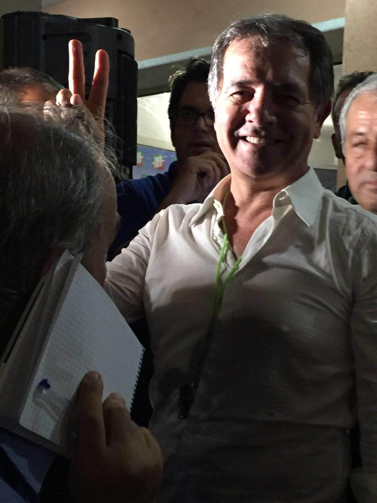 Settimo Nizzi fa il segno della vittoria dopo essere stato eletto sindaco di Olbia