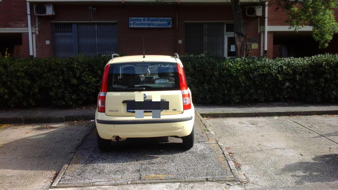 Multata auto in sosta sulla rampa per disabili 