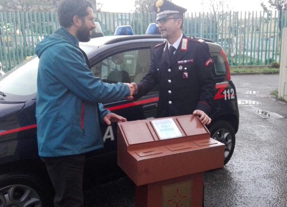 Il parroco don Lorenzo Lodi riceve la cassetta delle offerte ritrovata dai carabinieri
