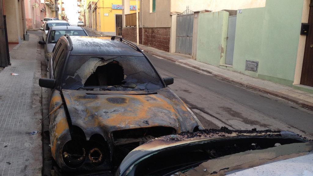 L'auto bruciata nella notte a Porto Torres (foto Masia)