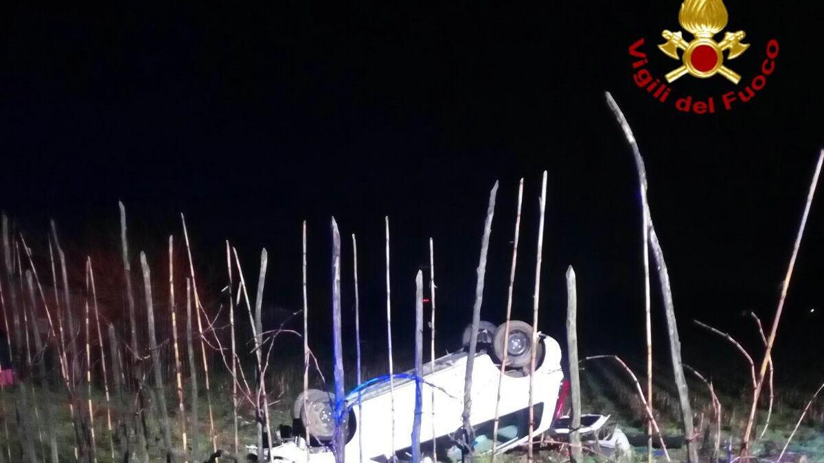 L'auto ribaltata nel campo (Foto Vigili del fuoco)