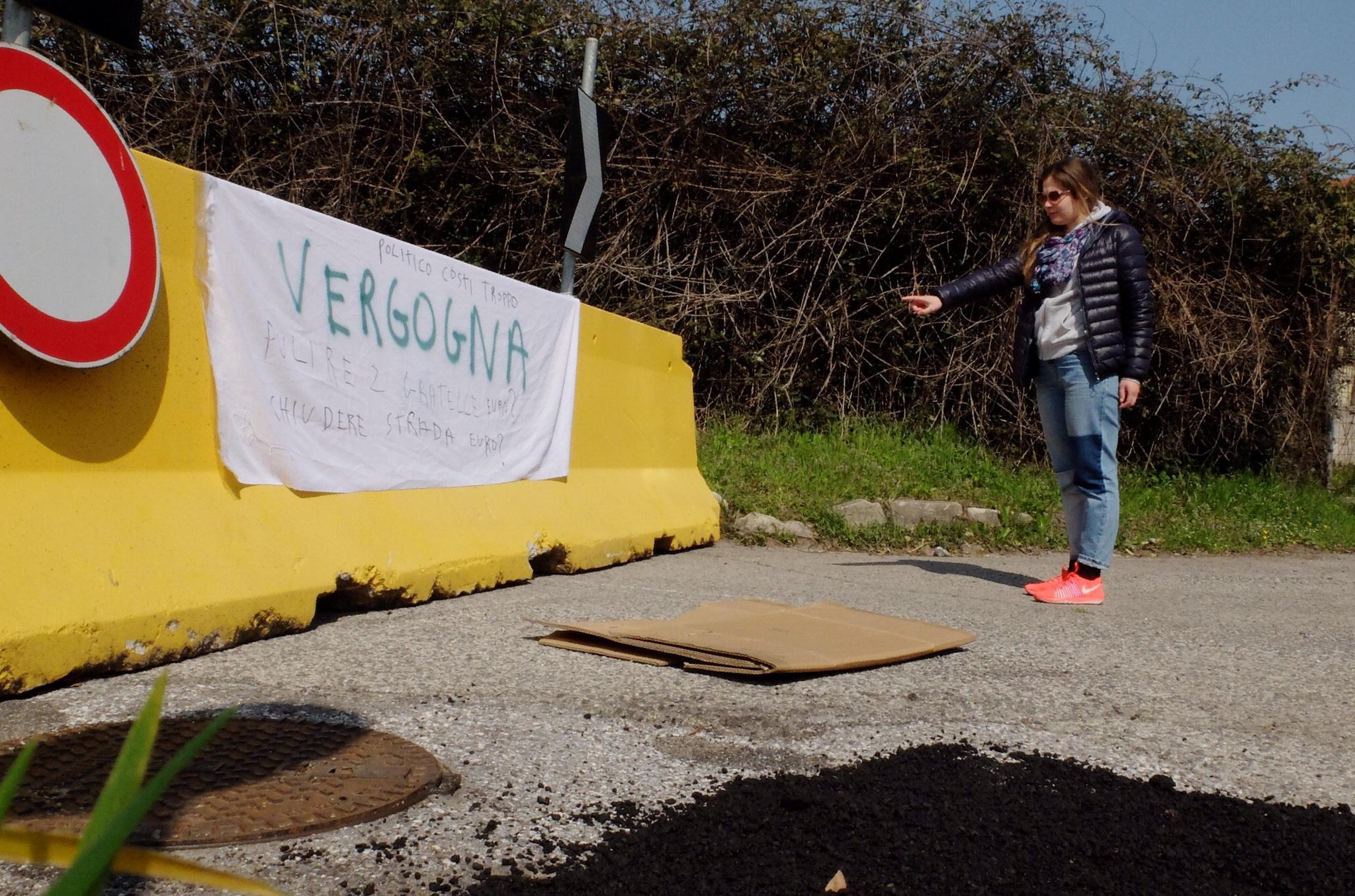 Uno striscione di protesta sulla barriera in cemento che chiude via Del Becarello (foto Sproviero/Batavia)