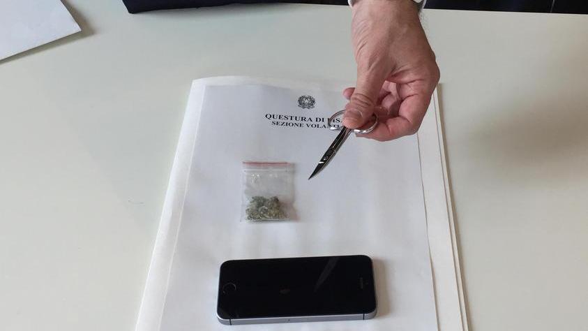L'iPhone rubato e la marijuana sequestrata, con le forbicine usate per ferire la vittima tenute in mano dal capo di gabinetto della questura pisana, Paolo Pizzimenti