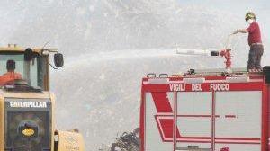 Sopra e a destra, due momenti dell’incendio in corso ai rifiuti stoccati all’interno della Lonzi Metalli