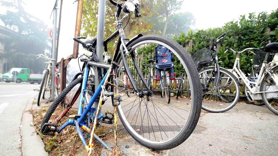Una bicicletta saccheggiata dai ladri di pezzi di ricambio davanti alla stazione
