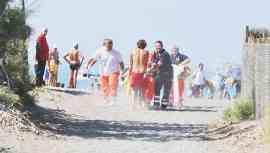 La vittima viene portata via dalla spiaggia per la corsa all’ospedale che si rivelerà vana